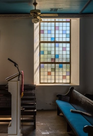 Vertical window with colorful class in church
