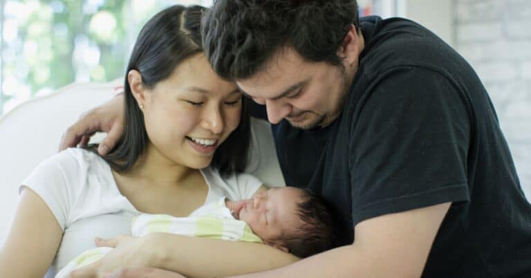 parents holding new born baby