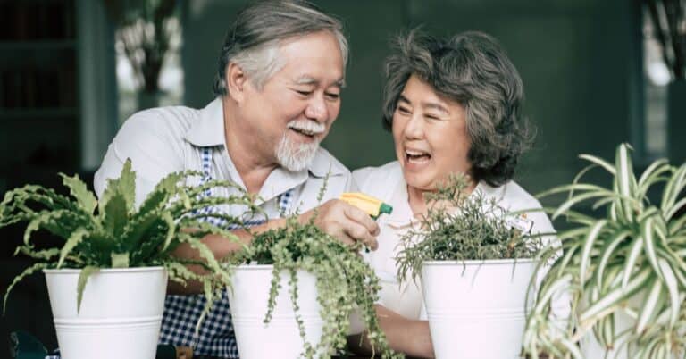 Older couple watering plants